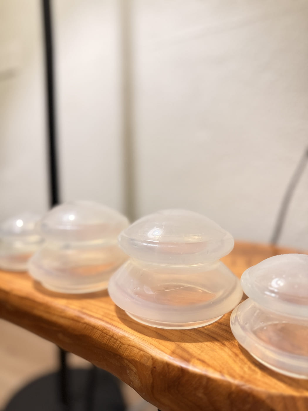 Silicone cupping cups on a wooden table in Joelle's treatment room